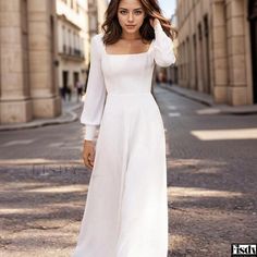 a woman in a white dress is walking down the street with her hand on her head