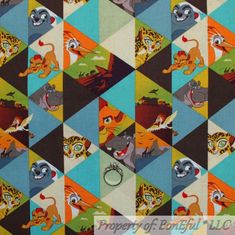 an animal themed fabric with many different colors and designs on it, including cats, lions, and other animals