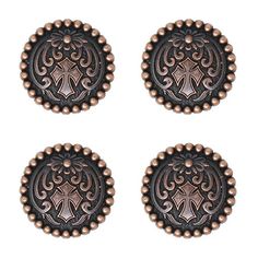 four metal buttons with ornate designs on them