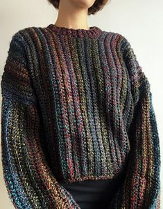 a woman wearing a multicolored knitted sweater