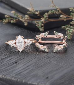 two rose gold wedding rings with pear shaped diamonds and leaves on the sides, sitting next to each other