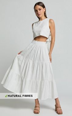 Discover the perfect look in our Ruby Midi Skirt, the dreamy addition to elevate your wardrobe! Breezy, flirtatious, and crafted with the softest cotton, this shirred high-waist maxi skirt is a versatile stunner in off-white that whispers casual elegance and playful charm. Whether you're stepping out for a sun-drenched beach day or accessorizing for a backyard party, the Ruby Midi Skirt is your new go-to for making unforgettable memories. Product Details: Pull on style Slip skirt A-line skirt Co Chic Tiered Gathered Maxi Skirt, Spring Breezy Gathered Maxi Skirt, Gathered Maxi Skirt For Day Out, Spring Breezy Flared Maxi Skirt, Breezy Flared Maxi Skirt For Spring, Chic Gathered Maxi Skirt For Day Out, Chic Cotton Tiered Skirt, Feminine Solid Color Maxi Skirt For Summer, White Feminine Maxi Skirt With Elastic Waistband