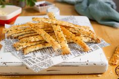 some bread sticks are sitting on top of newspaper