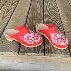 Nwot. Authentic Red Clogs Handmade In Hungary By A Hungarian Cobbler/Artist Who Runs A Small Shop, M & D Shoes. Imported By Me And Sadly Too Big. All Leather And Wood With Traditional Kolosca White Embroidered Motif. 2” Heel, 9 3/8” Length. True Size 7. Bought For $110.00 Usd. Will Sell To A Good Home For $65.00. Red Mules With Rubber Sole For Spring, Spring Red Clogs With Wooden Heel, Traditional Leather Clogs For Spring, Red Closed Toe Clogs With Rubber Sole, Red Closed Toe Clogs With Leather Sole, Traditional Slip-on Clogs With Rubber Sole, Red Clogs With Wooden Heel And Round Toe, Red Closed Toe Clogs With Wooden Heel, Red Slip-on Clogs With Wooden Heel