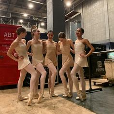 five young ballerinas are posing for the camera