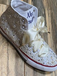 Embroidered Converse! Monochrome All WHITE Converse with white and ivory mixed pearls and rhinestones encrusted all over the shoe. ! I can do all white pearls or all ivory. (I will do the mixture if you do not specify in your order ) These shoes will sparkle and get noticed across the room! They are beautifully embroidered and hand done and each pair will be a bit different. This listing shows the I Do pattern but I can put your name or monogram on them as well as the date or Mrs. Smith. Your ch White Pearl Wedding Shoes For Bridal Shower, Elegant Wedding Sneakers With Rhinestones, Wedding Lace-up Sneakers With Rhinestones, Wedding White Embellished Sneakers, Embellished Lace-up Sneakers For Weddings, Elegant Embellished Sneakers For Wedding, Elegant White Sneakers For Bridal Shower, Elegant Embellished White Sneakers, Elegant White Embellished Sneakers