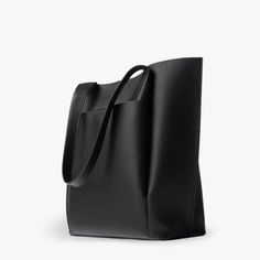 The All Day Tote is our take on the perfect bag for the go-getter. Made from our Premium Vegan Leather, it is soft to the touch and light weight. It opens up to an extra spacious interior that will can comfortably fit your everyday essentials. Carry it by the durable handle straps or over your shoulder. Perfect for wor Black Work Bags For Women, Black Work Bag, Leather Tote Bag For School, Women’s Work Bag, Tote Bag Leather Women, Black Leather Work Bag, Best Work Bags For Women, Shoppers Bag, Work Bags For Women