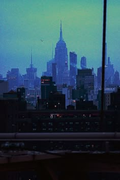 the city skyline is lit up at night, as seen from an apartment window in new york