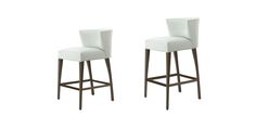 two white leather bar stools with arms and backrests on an isolated background