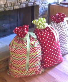 three bags sitting on top of a wooden floor next to a fire place in a living room