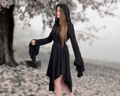 Step into an enchanting realm of style and sophistication with our meticulously crafted Black Hooded Witch Gothic Dress. Designed with a touch of dark allure and a dash of Renaissance inspiration, this dress is bound to make you the center of attention wherever you go. Here's why our dress deserves a place in your wardrobe: ✓ Unveil Your Elegance: Draped in the richness of black, this dress exudes an air of nobility that complements your personality. The captivating asymmetrical design, coupled Black Medieval Dress For Halloween, Medieval Style Black Dress For Halloween, Gothic Fitted Medieval Dress For Halloween, Fitted Black Medieval Dress For Halloween, Black Gothic Medieval Dress For Halloween, Gothic Medieval Dress For Fall Costume Party, Black Long Sleeve Medieval Dress For Halloween, Black Witchy Medieval Dress For Costume Party, Black Witchy Medieval Dress For Halloween