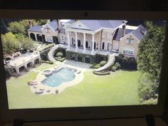 an aerial view of a large house with a pool in the yard and steps leading up to it