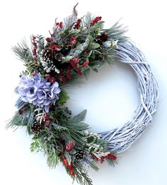 a christmas wreath with flowers and greenery