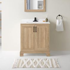 a bathroom with a sink, mirror and towel rack on the wall next to it