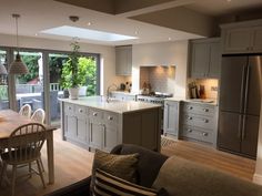 an open kitchen and living room with sliding glass doors leading to the outside deck area