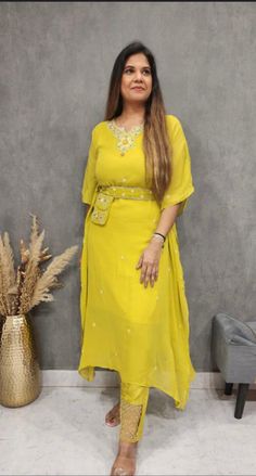 Beautiful Ethnic, yellow kaftan Kurta Pant set for women. Stylish Ready to wear yellow Kaftan Kurta pant set with hand embroidery and stylish pants, Indo western outfit.Relaxed and comforttable outfit for pre wedding festivities. It is stitched and ready to wear. This designer suit have hand embroidery on the neck and belt and beautiful detailing at the bottom of pant that makes it so elegant to wear. Material : Georgette Sleeves: Kaftan Style Kurti and Trouser has hand embroidery on the neck,pa Summer Maxi Length Georgette Kurta, Yellow Dabka Kurta For Eid, Yellow Maxi Length Sets For Navratri, Yellow Maxi Length Sets For Festive Occasion, Yellow Festive Maxi Length Set, Yellow Maxi Length Festive Set, Yellow Straight Kurta For Eid, Bollywood Style Summer Kurta In Maxi Length, Bollywood Style Summer Maxi Kurta