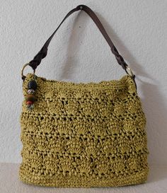 "Mustard color shoulder/tote bag- looks like hand knitted Light weight Gold tone hardware 100% paper and vinyl trim Brown fabric lining Two interior open pockets - one zipper pocket the other open pocket Zipper closure - zipper handle with wood decor Great condition Dimension length 15.5: height 12\" depth 5\" strap drop 9\"" Summer Handheld Hobo Bag With Leather Handles, Casual Bucket Hobo Bag With Handles, Eco-friendly Yellow Crochet Bag For Vacation, Casual Square Hobo Bag With Braided Handles, Casual Handwoven Satchel Shoulder Bag, Casual Green Handheld Crochet Bag, Yellow Crochet Bucket Bag For Summer, Yellow Bucket Crochet Bag For Summer, Summer Yellow Bucket Crochet Bag