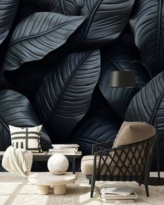 a living room with black leaves on the wall and a chair in front of it