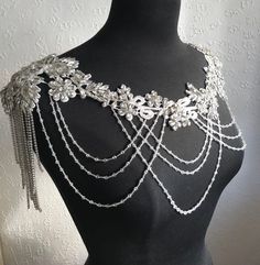 Create a stunning look to your bridal gown with this beautiful rhinestone/crystal shoulder necklace. This will really add a touch of elegance to your attire and you will become a shining star.  A beautiful accessory for a wedding, parties, Valentines Party, Anniversary, and any special occasion. It is simple to to put on and take off. The necklace is handmade to order and is available in silver as shown. The real thing is more beautiful than the pictures.   One of a kind pieces that will make yo Wedding Crystal Beaded Rhinestone Necklace, Crystal Embellished Necklaces For Wedding, Elegant Embellished Rhinestone Necklace For Wedding, Beaded Crystal Bridal Necklace For Wedding, Crystal Embellished Wedding Jewelry, Wedding Crystal Embellished Necklace, Wedding Crystal Embellished Jewelry, Crystal Bridal Necklace With Rhinestones For Wedding, Glamorous Embellished Rhinestone Necklace For Wedding