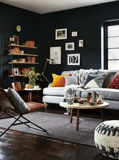 a living room filled with furniture and lots of books on the shelf above it's coffee table