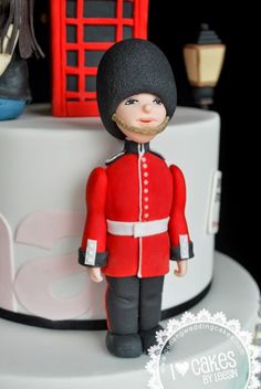 a close up of a cake with a figurine on top