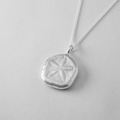 Step into summer with this radiant Sand Dollar Pendant. Inspired by the delicate skeletons of sand dollars, said in folklore to be the lost currency of mermaids, this pendant captures the ocean's charm. Unlike its fragile natural counterpart, this pendant will never crumble or tarnish, ensuring it remains a timeless keepsake. Perfect for casual outfits, resort wear, or adding a playful touch to date night, this necklace is a versatile addition to your collection. Each piece comes beautifully pac Sand Dollar Pendant, Sand Dollars, Jewelry Workshop, Sand Dollar, Sunshine Coast, Necklace Handmade, Sterling Silver Necklace, Queensland, Resort Wear