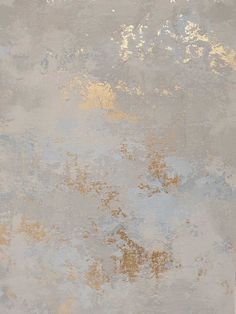 an old, dirty wall with gold paint on it