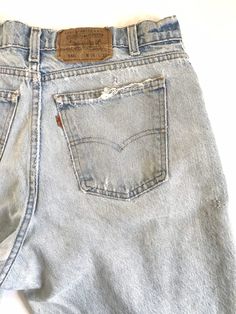 "Waist:34\" Rise:12.5\" Hips:44\" Inseam:30.5\" These 550's are USA made and super shredded with repairs, rips and some stains and discoloration. They're the epitome of Levis grunge jeans from the 90's with the ultra high rise, zip fly and light wash with tapered leg. Please refer closely to the photos for the stains, repairs and rips. They're tagged a vintage 36\" but bets fit a modern 34\". Measurements are provided above for an accurate fit. 🍑(2)" Acid Wash Distressed Cutoff Jeans, Retro Ripped Light Wash Bottoms, Vintage Distressed Jeans For Spring, Vintage Jeans With Frayed Hem, 90s Style Distressed Faded Jeans, 90s Distressed Faded Jeans, 90s High Waist Distressed Jeans, Grunge Style Light Wash High Rise Jeans, Grunge Light Wash High Rise Jeans