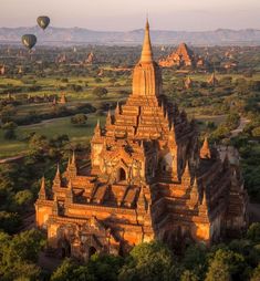 hot air balloons flying over the temples in bagan