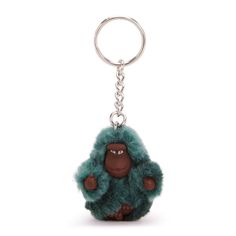 a keychain with a gorilla on it's face and hands in the shape of an animal