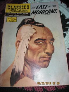 an old book with a native american man's face and feathers on the cover