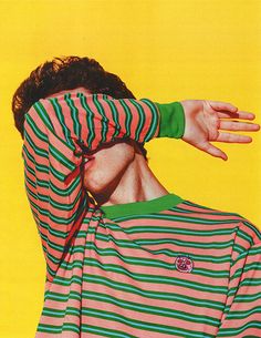 a man with his face covered by a striped shirt