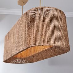 a woven light fixture hanging from a ceiling