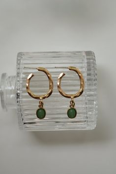 Our Dusk of Hope Earrings have a one of a kind twisted hoop that connects to a green pendant. These earrings are super light weight and dainty! Color - Green & Gold Material - Stainless Steel Measurements - 1.75 Inches Long Green Teardrop Metal Earrings, Green Teardrop Nickel Free Hoop Earrings, Green Teardrop Nickel-free Hoop Earrings, Trendy Brass Dangle Hoop Earrings, Nickel-free Green Teardrop Hoop Earrings, Trendy Dangle Hoop Earrings In Brass, Everyday Green Circular Earrings, Elegant Green Circular Earrings, Green Metal Dangle Earrings