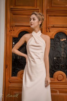 "This luxury dress design is perfect for any occasions. 100 % designed and handmade by Emsilk. I am pleased to offer your garments made to measure at no extra cost. This dress can be made in different colors that you find in my shop. Link to all colors in pure silk: https://www.etsy.com/shop/emsilkdesign?ref=seller-platform-mcnav&section_id=28483599 * Detail: - Halter twisted neckline - Silk covered buttons closure - Invisible zipper on the back. - Bias cut hemline - Fully lined with the sam Silk Fitted Halter Dress For Wedding, Cream Halter Neck Party Dress, Silk Halter Dress For Wedding, Silk Halter Neck Dress For Wedding, Chic Backless Silk Dress For Wedding, Wedding Silk Halter Dress, Chic Backless Silk Wedding Dress, Elegant Halter Neck Mini Dress For Wedding, Chic Cream Satin Dress For Party