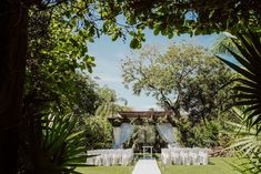 an outdoor wedding setup with white linens and chairs