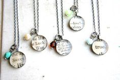 five different necklaces with words on them