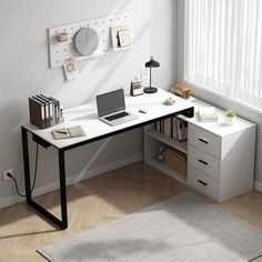 a computer desk with a laptop on top of it next to a white rug and window