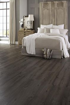 a bedroom with wood floors and gray walls