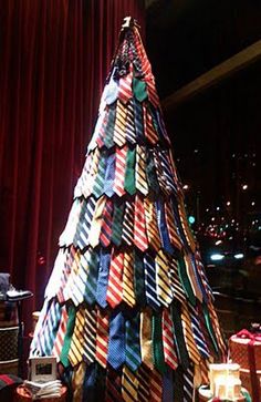 a christmas tree made out of ties in a room