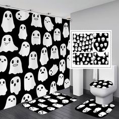 a bathroom decorated in black and white with ghost themed shower curtain, toilet seat covers and rugs