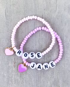 Girls Name Bracelets - Candy Colored The sweetest name bracelet for your little girl. And makes a great gift or baby shower gift ✨ Candy colored 3mm seed beads with personalized name and heart charm Color options available* CARING TIPS FOR YOUR JEWELRY ⭐️Treat and store with care. ⭐️ For longevity, avoid exposing your jewelry to water. ⭐️ Avoid having direct contact with lotions, perfumes, sanitizers as these chemicals may cause discoloration of your jewelry. Customizable Pink Charm Bracelet For Friendship, Cute Heart Bracelet With Round Beads For Valentine's Day, Cute Letter Beads Stretch Bracelet For Valentine's Day, Cute Stretch Bracelet With Letter Beads For Valentine's Day, Custom Name Pink Charm Bracelet For Mother's Day, Personalized Pink Round Bead Name Bracelet, Cute Heart Beads Charm Bracelet For Valentine's Day, Cute Heart Beads Beaded Bracelets For Valentine's Day, Personalized Pink Name Bracelet With Round Beads