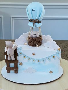 a cake that is shaped like a baby's cradle with a teddy bear in it