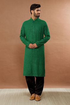 Festive green kurta with sequin embroidery and mandarin collar. Paired with black patiala.
Component: 2
Pattern: Embroidered
Type Of Work: Sequin
Neckline: Mandarin
Sleeve Type: Full
Fabric: Cotton
Color: Green
Other Details: 
Sequin work
Occasion: Mehendi and Puja - Aza Fashions Pista Green Kurta With Mirror Work For Eid, Green Straight Kurta With Resham Embroidery, Green Embroidered Chanderi Bandhgala, Green Traditional Wear With Sequins For Navratri, Green Embroidered Party Kurta, Green Sequined Traditional Wear For Navratri, Party Green Embroidered Kurta, Traditional Green Sequined Wear, Semi-stitched Green Chanderi Sherwani