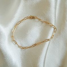 1/20 14k stamped for gold filled authenticity. The perfect unisex paperclip chain bracelet that goes with any stack or can be worn alone for a more minimalist look. Material: 14k gold filled with lobster clasp. *Handcrafted Gold filled is waterproof, tarnish resistant, hypoallergenic, lead + nickel free. Modern Everyday 14k Gold Filled Bracelet, Gold-plated Paperclip Chain Bracelet, Classic 14k Gold Filled Bracelet With Delicate Chain, Classic 14k Gold-filled Bracelet With Delicate Chain, Classic 14k Gold Filled Delicate Chain Bracelet, Classic Hypoallergenic Chain Bracelet For Everyday, Classic Gold Chain Paperclip Bracelet With Rectangular Links, Gold-plated Oval Link Paperclip Bracelet With Lobster Clasp, Gold Plated Oval Link Paperclip Bracelet With Lobster Clasp