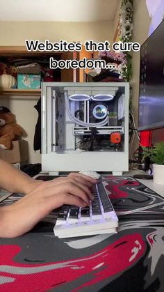 a person is typing on a laptop with an image of a 3d printer in the background