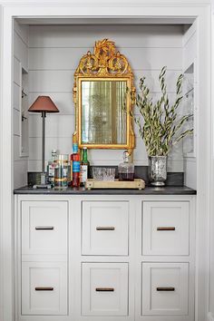 there is a mirror and some bottles on top of the dressers in this room