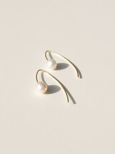 These classic threader earrings are so versatile, they can be dressed up for bridal ware or dressed down with a summer dress or pair of jeans. Beautifully imperfect and full of grace, just like the grit in the oyster. Wear it as a symbol of perseverance and wisdom accumulated through life's ample trials and tribulations. Triple plated premium brass over 925 sterling silver for superior tarnish resistance Hypoallergenic and nickel free 1 3/4" total length Cultured freshwater baroque pearl Sustain Everyday White Threader Earrings, Minimalist White Threader Earrings For Everyday, Minimalist Long Drop Pearl Earrings With Ear Wire, Everyday Linear Drop Earrings With Pearl Detail, Everyday Pearl Drop Linear Earrings, Everyday Linear Drop Earrings With Pearl, Everyday Linear Pearl Drop Earrings, Adjustable Linear Elegant Earrings, Dainty Long Drop Pearl Earrings For Everyday