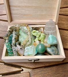 a wooden box filled with lots of different types of rocks and stones in it's lid