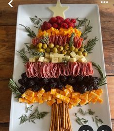 a christmas tree made out of fruits and veggies on a white platter